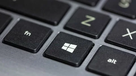 Finger pressing the Windows 10 operating system key on a laptop keyboard Stock Footage 143016028