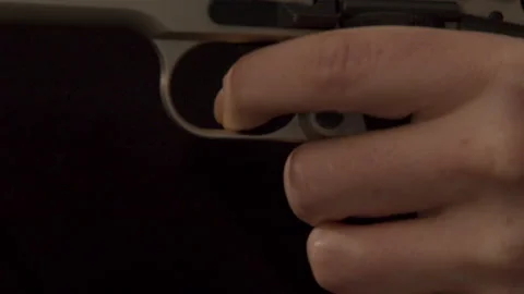 Finger pulling trigger of pistol in slow... | Stock Video | Pond5