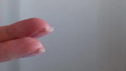 Finger push button on cream bottle in clean hand in bathroom. Skin care, hygiene Stock Footage 101702410