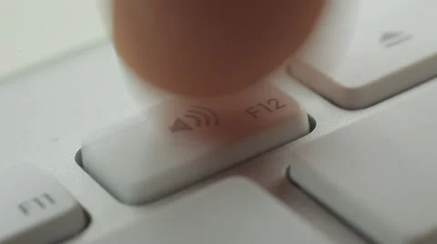 Finger Push F12 (Volume Up) Button of the Keyboard. Close up slow panorama Vidéo 50474635