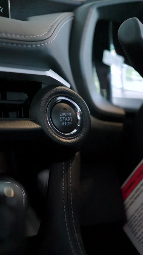 A finger pushes the keyless start-stop button of a new vehicle. Stock Footage 346269246