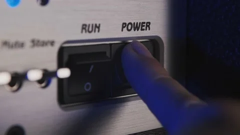 Finger pushes the switch button of a guitar amp Stock Footage 156606677