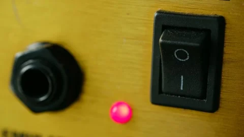 Finger pushing amplifier power switch turning on light Video stock 317905773