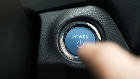 Finger Pushing blue button on  hybrid car engine key less ignition power, to  Stock Footage