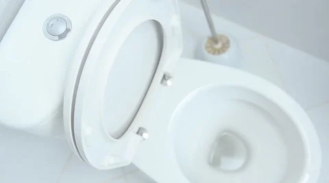 Finger pushing button and flushing toilet Stock Footage 57908246