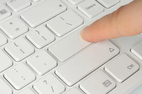 Finger pushing the button of keyboard Stock Photos