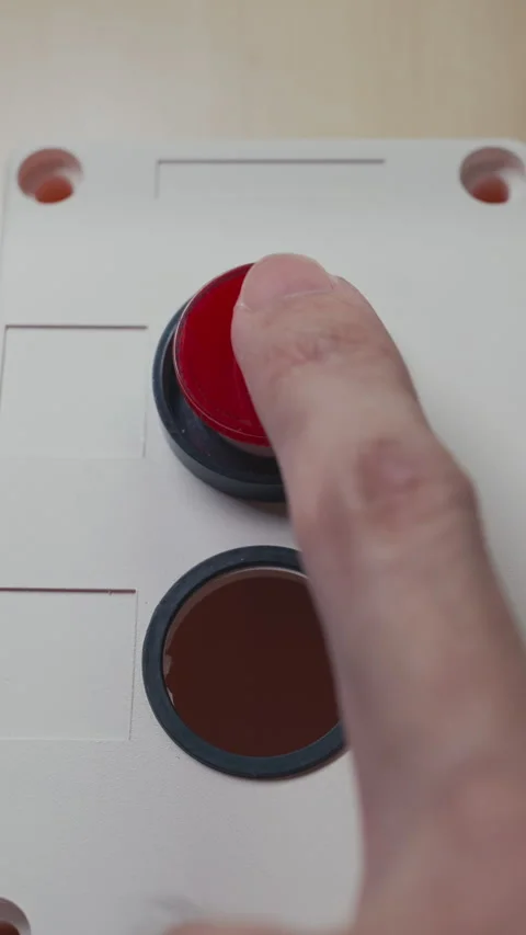 Finger Pushing a Red Button Resembling a Clown’s Nose on a White Face Stock Footage 330256248