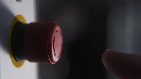 Finger pushing red button to start stop in factory Stock Footage 106235878