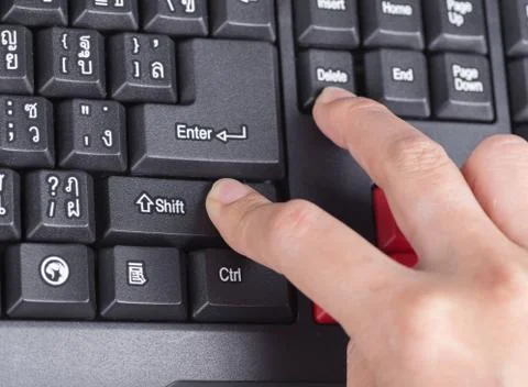 Finger pushing shift delete button on keyboard of computer Stock Photos