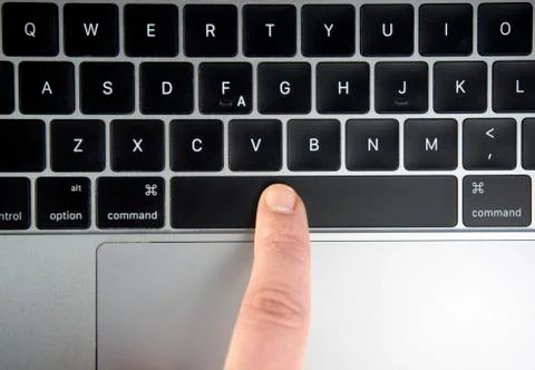 Finger pushing the space bar button of keyboard Stock Photos