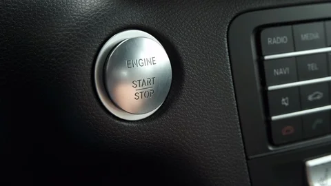 Finger pushing start engine button in a ordinary car close up Stock Footage 124752726