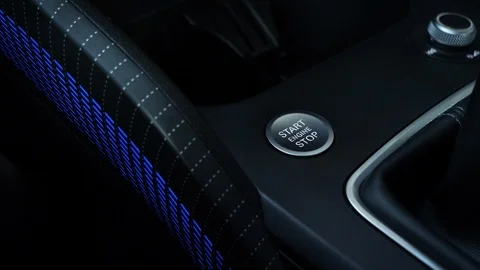 Finger pushing start engine button in a brand new modern car. Close up Stock Footage 124752762
