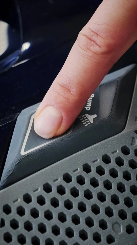 Finger pushing on water pump button on vacuum cleaner, close up. Vertical video Stock Footage 314674888