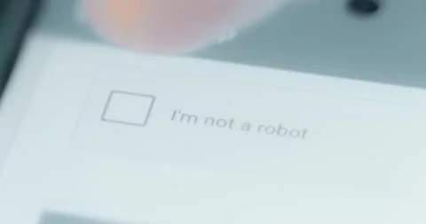Finger puts a check mark in front of the message I am not a robot. CAPTCHA Stock Footage 313621949