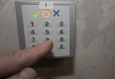 Finger putting in a numerical code on a electronic combination lock numeri... Stock Photos