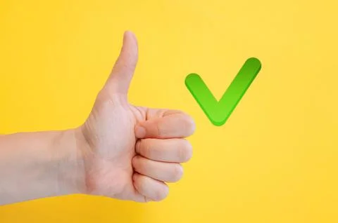 Finger raised up with green check mark, symbolizing approval, agreement Stock Photos