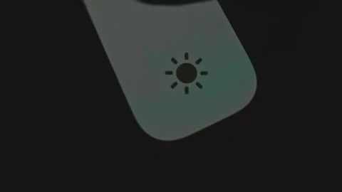 Finger raises the brightness level on device Stock Footage 302827589