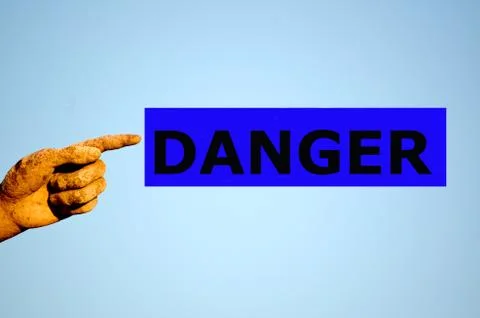 Finger with rectangular blue label DANGER Stock Photos