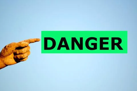 Finger with rectangular green label DANGER Stock Photos