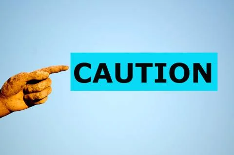 Finger with rectangular light blue label CAUTION Stock Photos