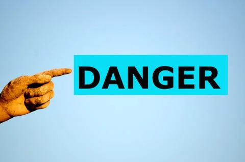 Finger with rectangular light blue label DANGER Stock Photos