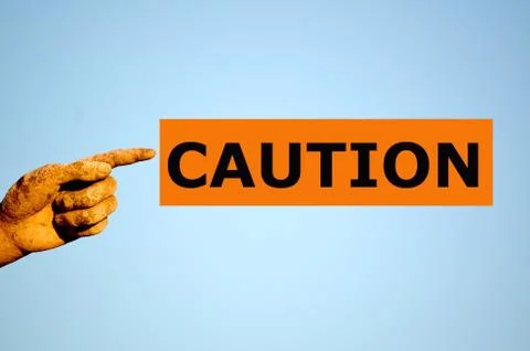 Finger with rectangular orange label CAUTION Stock Photos