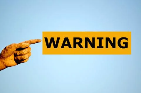 Finger with rectangular orange label WARNING Stock Photos