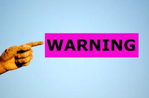 Finger with rectangular purple label WARNING Stock Photos