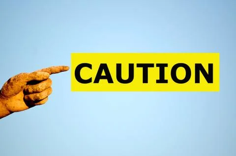 Finger with rectangular yellow label CAUTION Stock Photos