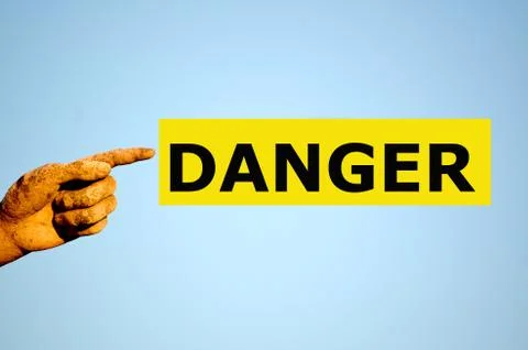 Finger with rectangular yellow label DANGER Stock Photos