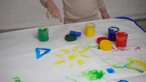 Finger safe childrens paints on the table and children's hands Stock Footage 169245225
