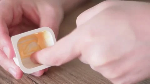 Finger in sauce. A man dips his finger into a cheese sauce. Harmful fast food Stock-Footage 131992520