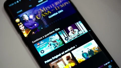 Finger Scrolling Amazon Prime Video App using Smartphone. Stock Footage 107879510