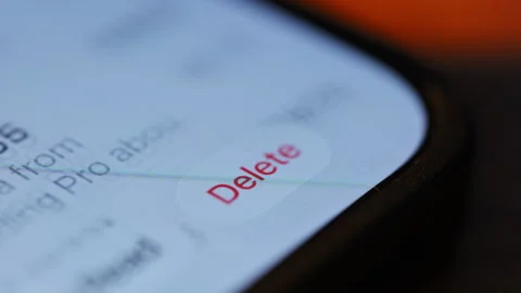 Finger scrolling and tapping Settings app icon on iPhone screen. Close up of iOS Stock Footage 334023146