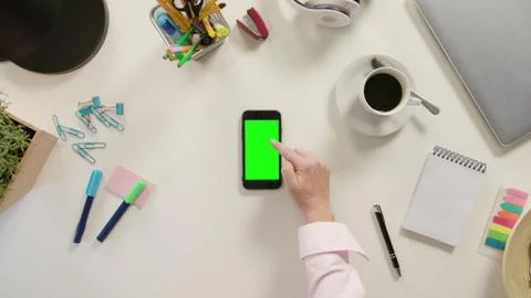A Finger Scrolling on the Green Touchscreen Stock Photos