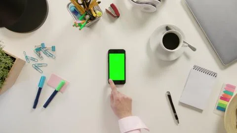 A Finger Scrolling on the Green Touchscreen Stock Photos