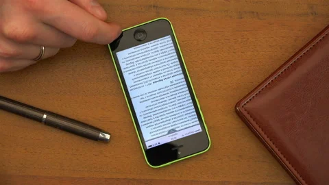 Finger scrolls email text across a smartphone display Stock Footage 100166381