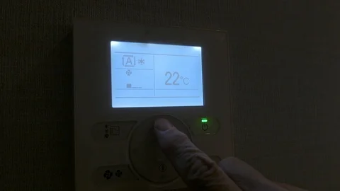 Finger sets the temperature on a  thermostat. Stock Footage 102649754