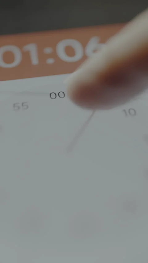 Finger setting the exact time on the digital clock for the upcoming event on a Stock Footage 328814320