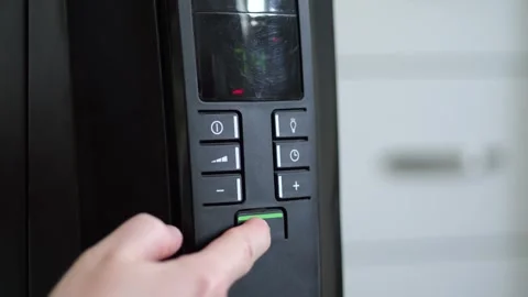 Finger setting temperature on modern electric heater in slow motion Stock Footage 307156072