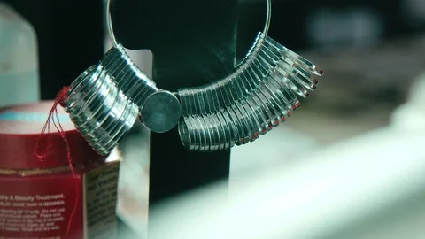 Finger sizing for rings hangs on a stand inside jewelry workshop Stock Footage 128463079