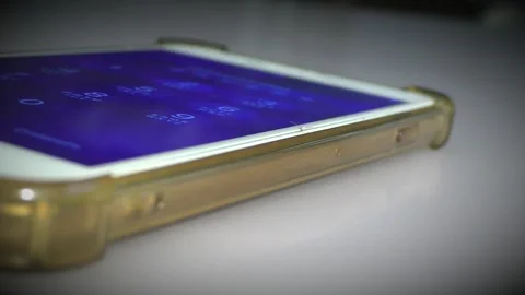 The finger on the smartphone dials the digits of the code. Stockbeeldmateriaal 304785137