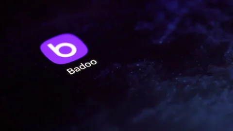 Finger tapping the Badoo icon to open the application on a smartphone. 動画素材 107167717