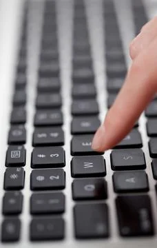 Finger tapping the keyboard Stock Photos