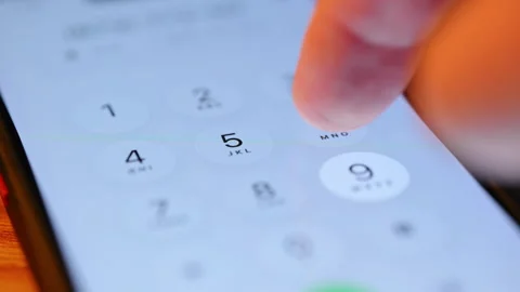 Finger tapping numbers to call and making a call on the iPhone screen. Close up Stock Footage 334022968