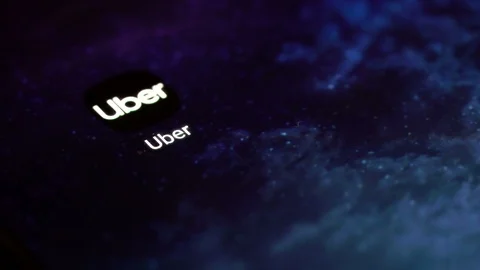 Finger tapping the Uber icon to open the application on a smartphone. Stock Footage 107168802