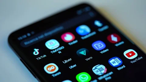 Finger tapping the Vero icon to open the application on a smartphone. Stock Footage 108563915
