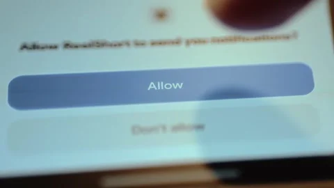 Finger taps the ALLOW button for receiving notifications Stock Footage 327522942