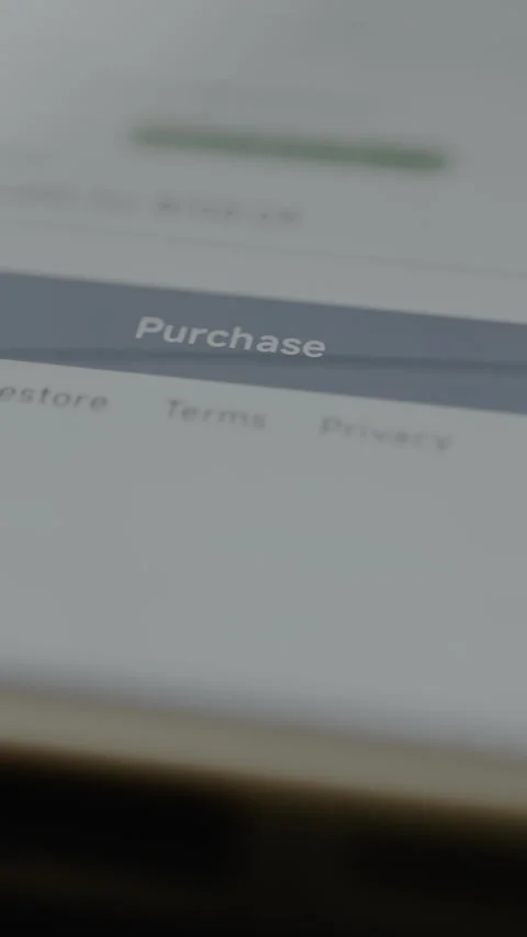 Finger taps the button labeled Purchase for an app subscription Video stock 328814230