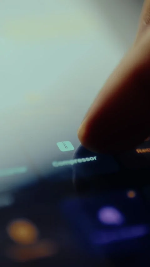 Finger taps the Compressor function within a video editing application Stock Footage 326947338